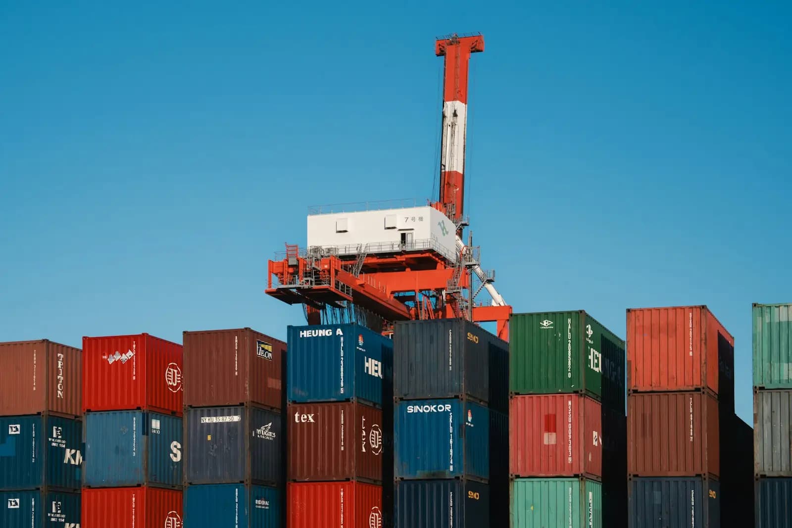 A crane above stacks of containers