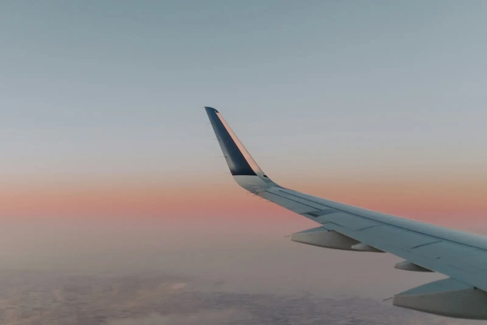 An airliner wing in the evening sky