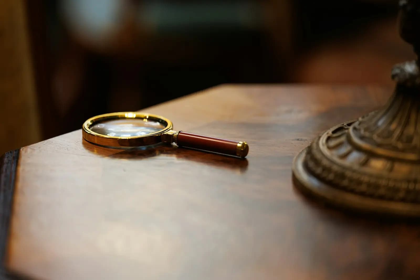 A magnifying glass on a wooden desk