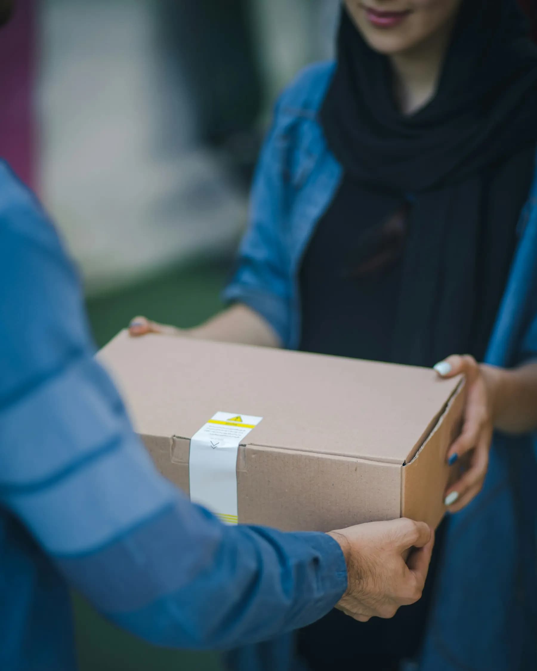 A parcel handed from one pair of hands to another